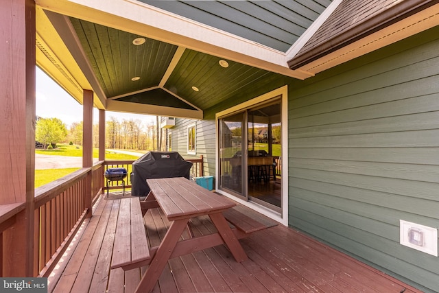 wooden terrace with a grill