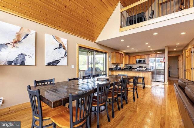 dining area featuring light hardwood / wood-style flooring, high vaulted ceiling, and wooden ceiling