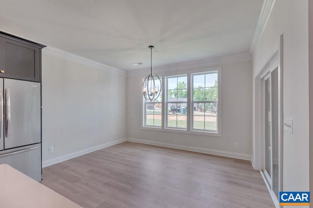 unfurnished dining area featuring a chandelier, light hardwood / wood-style flooring, and ornamental molding