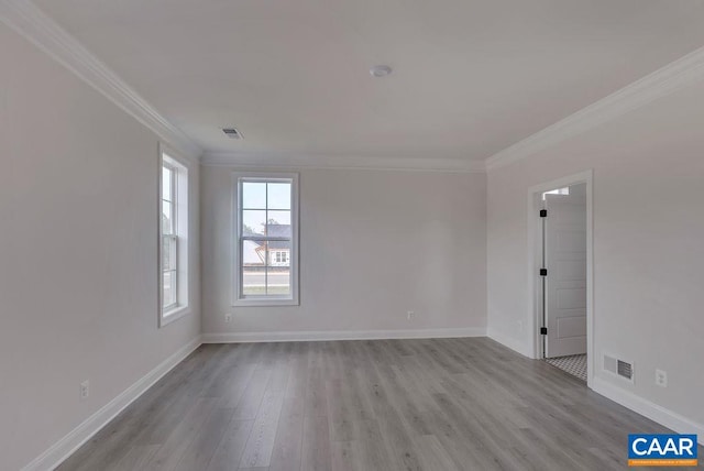 empty room featuring light hardwood / wood-style floors and ornamental molding