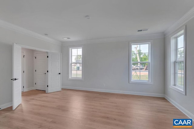 unfurnished bedroom featuring ornamental molding and light hardwood / wood-style flooring