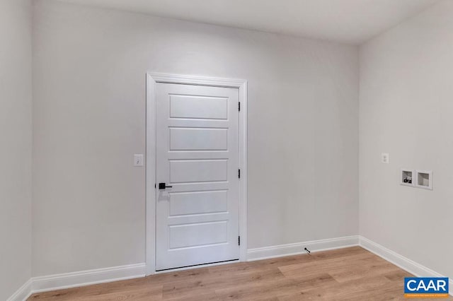 washroom with light hardwood / wood-style flooring and washer hookup