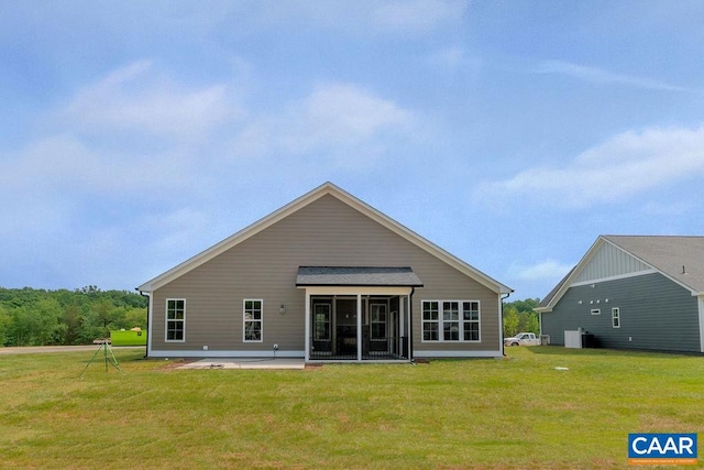 rear view of property featuring a yard and a patio