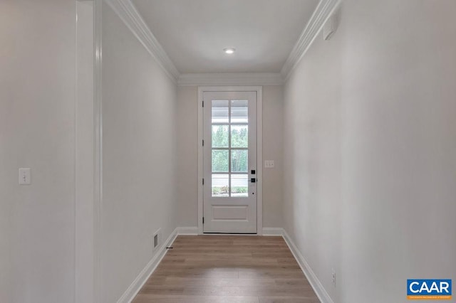 entryway with crown molding and light hardwood / wood-style floors