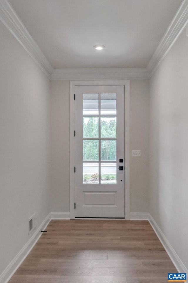 doorway featuring crown molding and light wood-type flooring