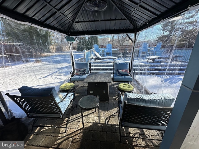 snow covered patio featuring a gazebo