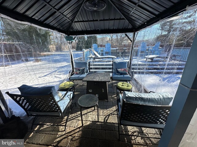 snow covered patio with a gazebo