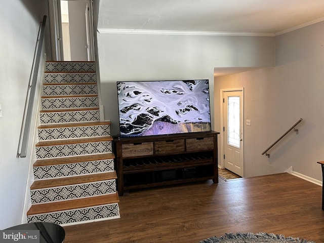 stairs with crown molding and hardwood / wood-style floors