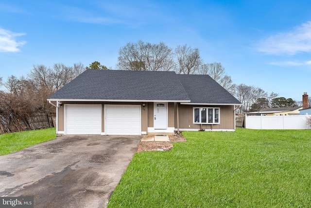 ranch-style house featuring a front yard and a garage