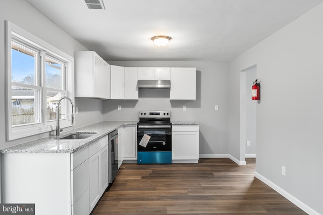 kitchen with light stone countertops, stainless steel appliances, sink, white cabinets, and dark hardwood / wood-style floors