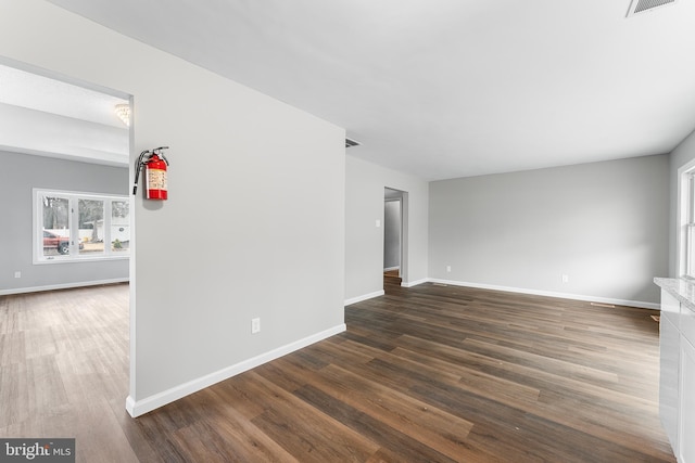 empty room with dark hardwood / wood-style floors