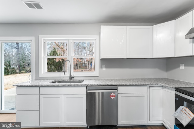 kitchen featuring dishwasher, sink, electric range oven, light stone counters, and white cabinets