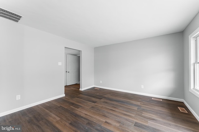 unfurnished room featuring dark hardwood / wood-style flooring