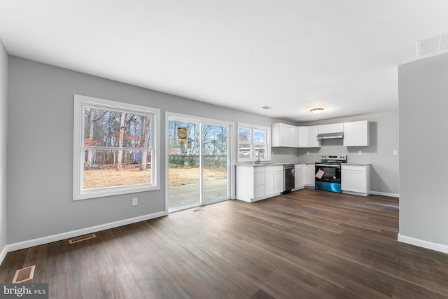 kitchen with white cabinets, dark hardwood / wood-style floors, and appliances with stainless steel finishes