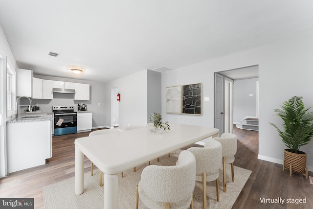 dining space with sink and hardwood / wood-style flooring