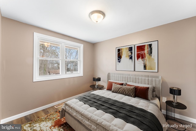 bedroom with hardwood / wood-style flooring