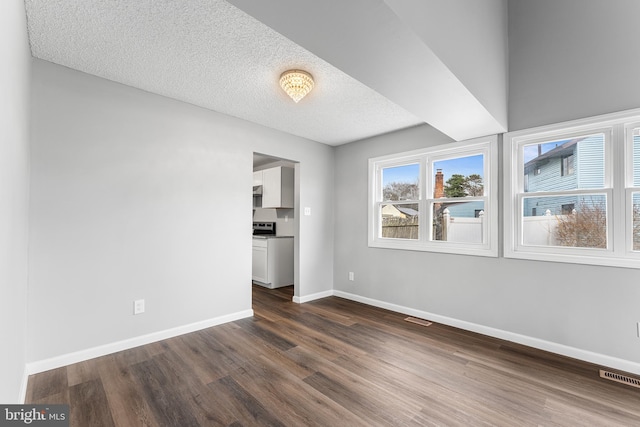 interior space with dark hardwood / wood-style flooring and a textured ceiling