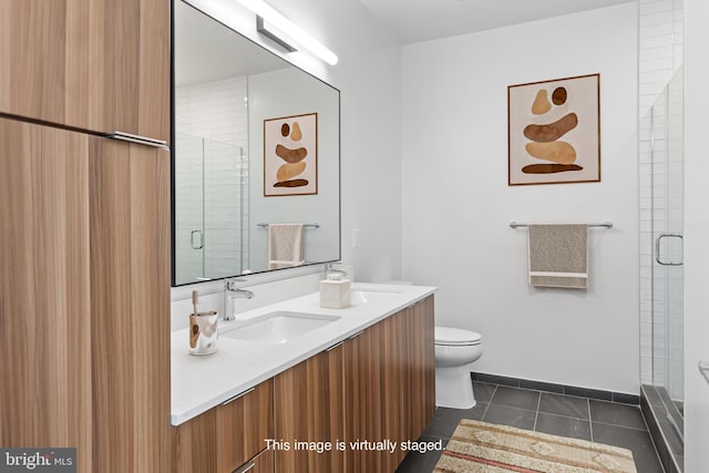 bathroom with tile patterned floors, vanity, toilet, and walk in shower