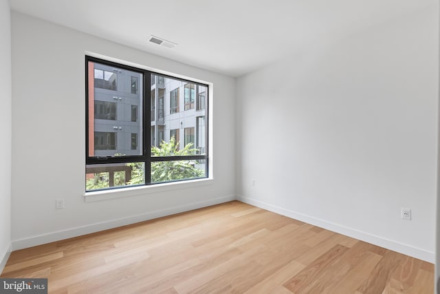 empty room with light hardwood / wood-style flooring