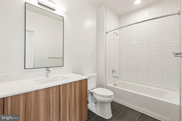 full bathroom featuring tile patterned floors, vanity, tiled shower / bath combo, and toilet