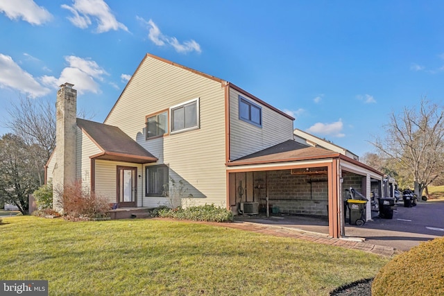 view of side of home with a lawn and central AC unit