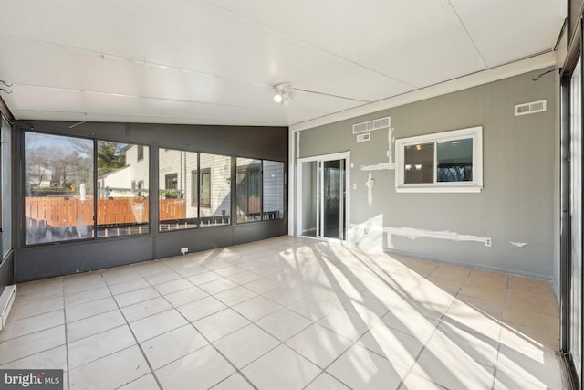 unfurnished sunroom featuring lofted ceiling