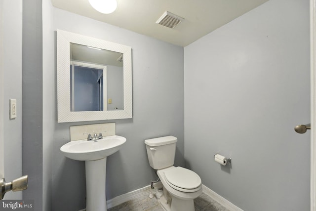 bathroom featuring toilet and sink