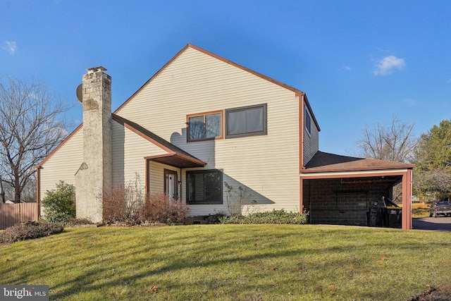 rear view of property featuring a lawn