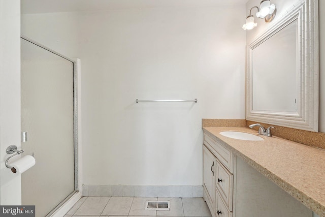 bathroom featuring tile patterned flooring and vanity