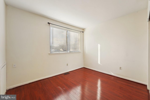 unfurnished room with wood-type flooring