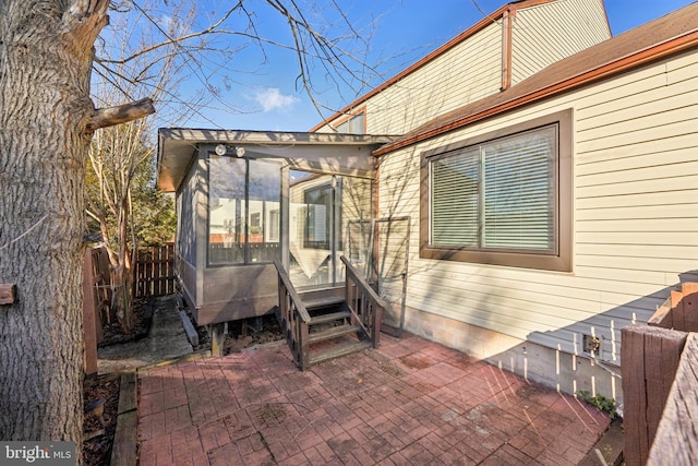 view of patio featuring a sunroom