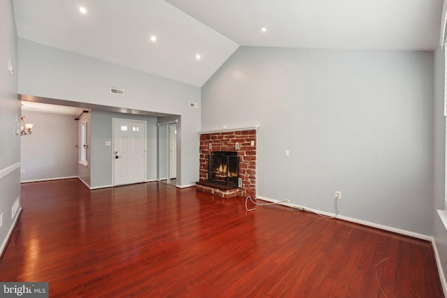 unfurnished living room with a fireplace, high vaulted ceiling, and dark wood-type flooring