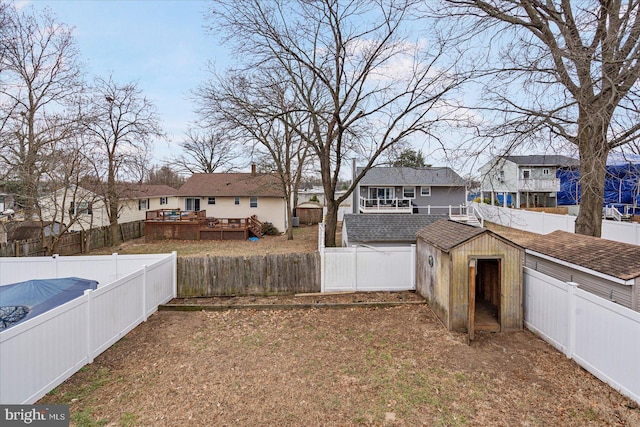 view of yard with a storage unit and a deck