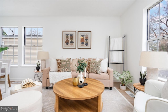 living room featuring a wealth of natural light and light hardwood / wood-style floors