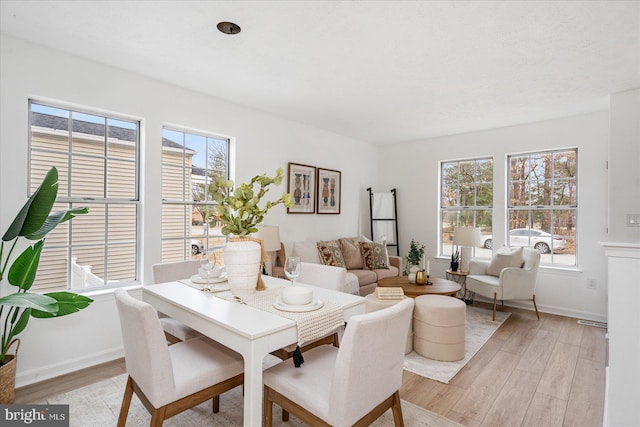 dining space with light hardwood / wood-style flooring