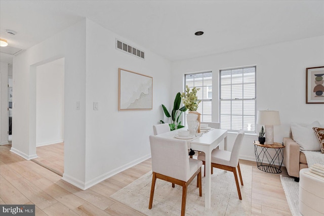 dining space with light hardwood / wood-style flooring