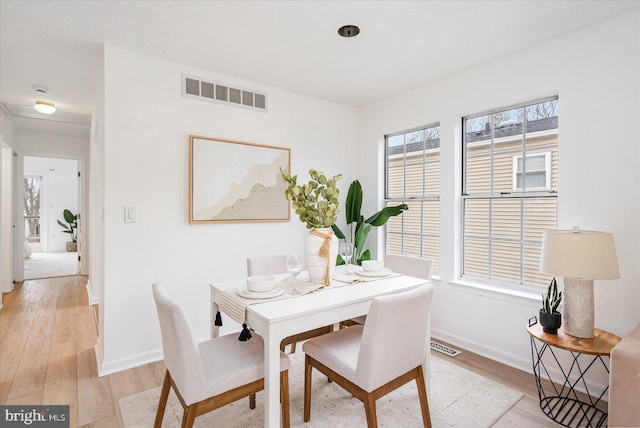 dining space featuring plenty of natural light and light wood-type flooring