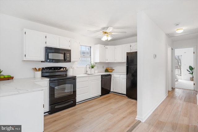 kitchen featuring white cabinets, light hardwood / wood-style flooring, ceiling fan, and black appliances