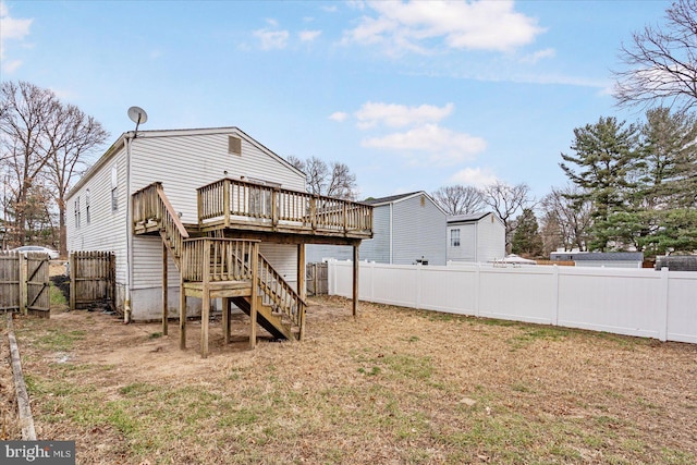 rear view of property with a wooden deck