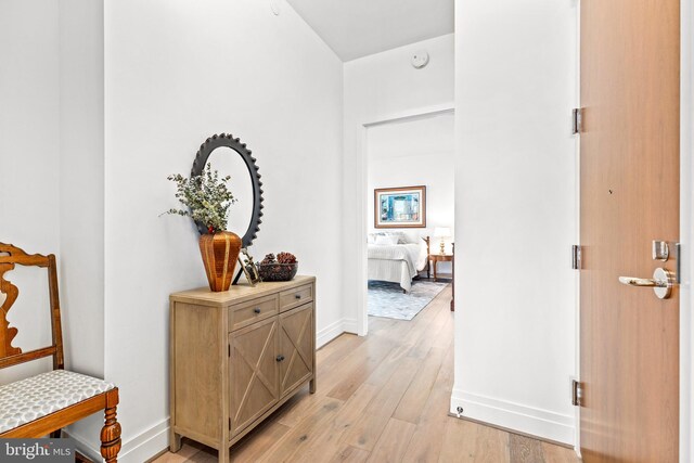 corridor with light hardwood / wood-style floors