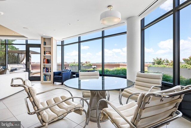 sunroom / solarium featuring a water view