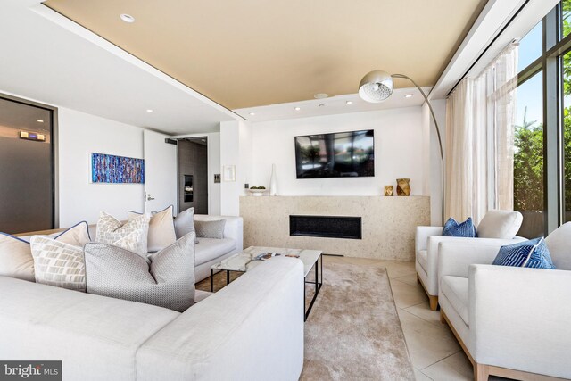 living room featuring light tile patterned flooring and a fireplace