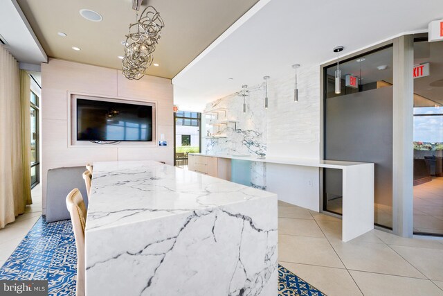 dining space featuring a chandelier and light tile patterned floors