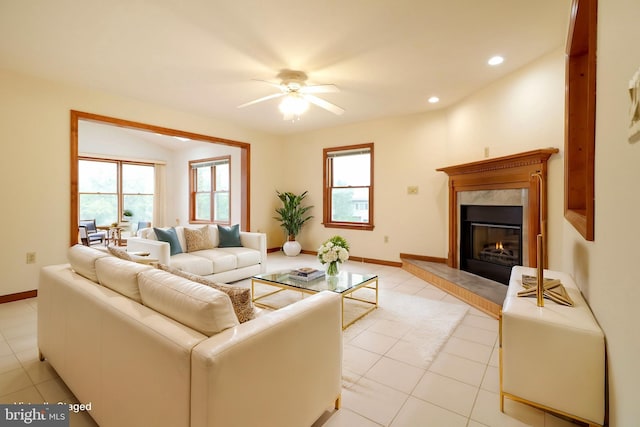 living room with light tile patterned floors, baseboards, recessed lighting, a high end fireplace, and ceiling fan