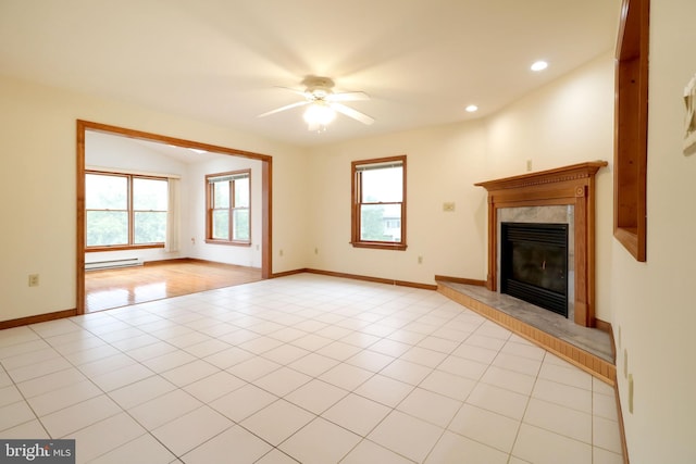 unfurnished living room with light tile patterned floors, a ceiling fan, baseboards, a baseboard radiator, and a high end fireplace