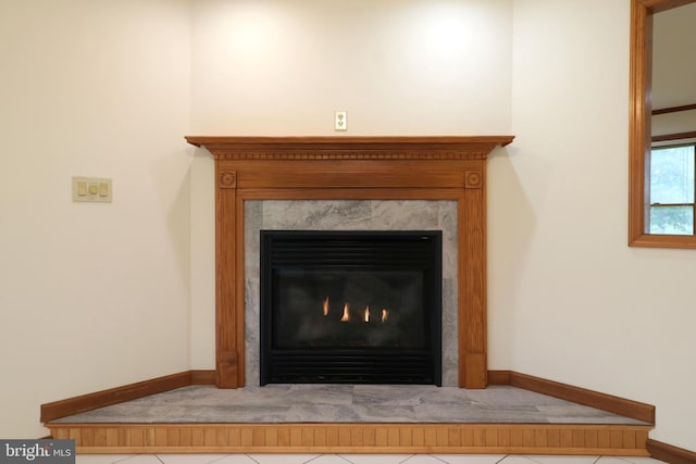 interior details with baseboards and a warm lit fireplace
