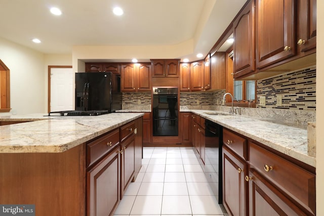 kitchen with decorative backsplash, black appliances, light tile patterned floors, and a sink