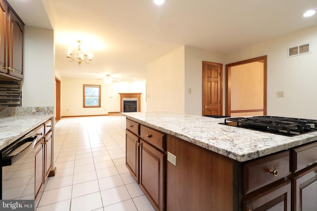 kitchen with visible vents, a chandelier, dishwasher, black cooktop, and light tile patterned flooring