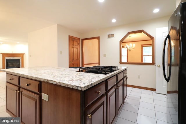 kitchen featuring visible vents, baseboards, recessed lighting, black appliances, and a notable chandelier