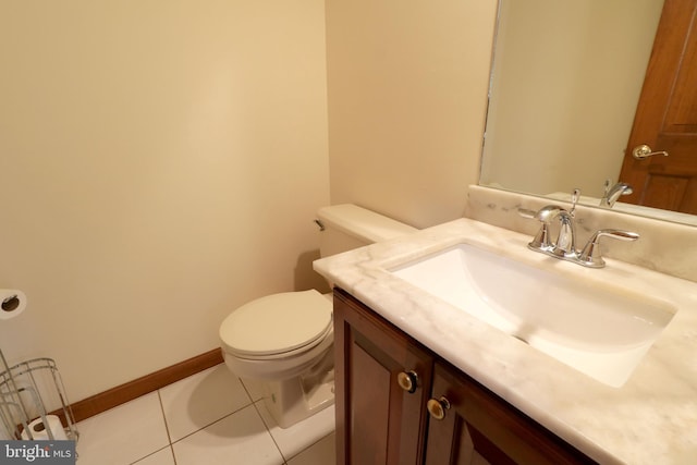 half bath featuring baseboards, toilet, vanity, and tile patterned flooring